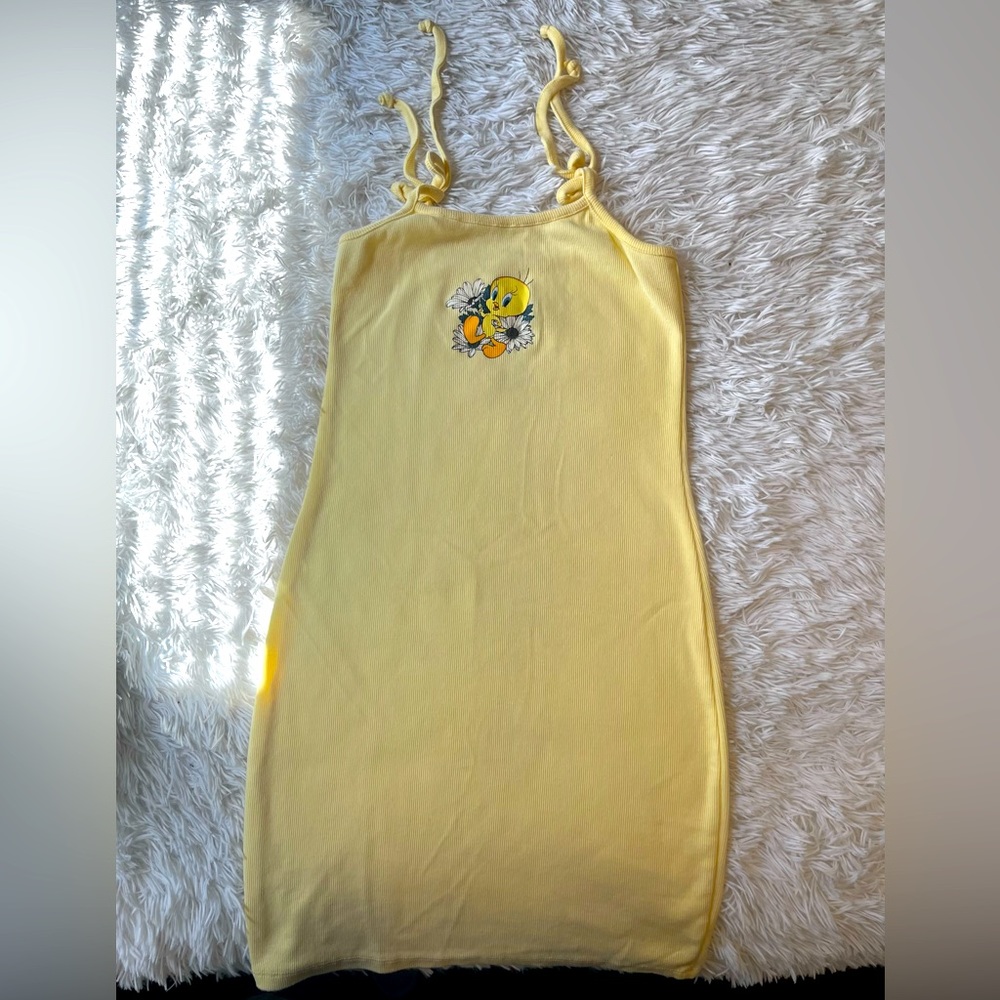 It’s a looney tunes in XS pastel yellow fitting dress